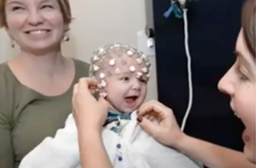 infant smiling getting brain network measurements with clinician and parent
