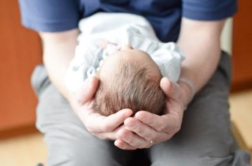adult holding infant