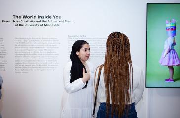 an artist speaking with a museum visitor