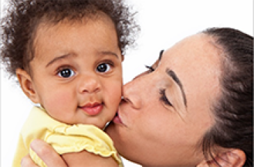 person kissing infant